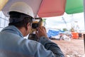 Surveyor builder engineer theodolite equipment during surveying work in new construction site Royalty Free Stock Photo