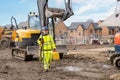 Surveyor builder site engineer with theodolite total station at construction site outdoors during surveying work Royalty Free Stock Photo