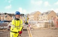 Surveyor builder site engineer with theodolite total station at construction site outdoors during surveying work Royalty Free Stock Photo