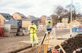 Surveyor builder site engineer with theodolite total station at construction site outdoors during surveying work Royalty Free Stock Photo