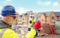 Surveyor builder site engineer with theodolite total station at construction site outdoors during surveying work Royalty Free Stock Photo