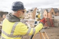 Surveyor builder site engineer with theodolite total station at construction site outdoors during surveying work Royalty Free Stock Photo