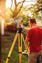 surveyor caucasian engineer working with total station theodolite at landscaping project Royalty Free Stock Photo