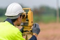 Surveyor Civil Engineer working theodolite or total positioning station on the construction site of the road or building with