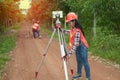 Surveyor or Engineer making measure with partner on a field. Royalty Free Stock Photo