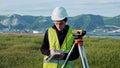 Surveyor engineer is measuring level on construction site. Geodesist ensure precise measurements before undertaking
