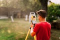 surveyor engineer measuring and working with total station