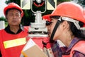 Surveyor or Engineer setting prism reflector with partner on the field. Royalty Free Stock Photo