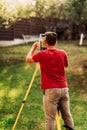 Surveyor engineer working on ground elevation - landscaping details Royalty Free Stock Photo