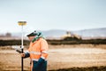 Surveyor engineer working with technology for coordinating heavy duty machinery Royalty Free Stock Photo