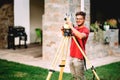 Surveyor engineer working with total station at landscaping project