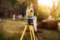 Surveyor engineering equipment with theodolite and total station in a garden