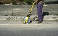 Surveyor with measuring wheel (odometer) detects the length of an excavation Royalty Free Stock Photo