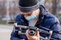 Surveyor in a protective mask prepares a quadcopter for flying around an object Royalty Free Stock Photo