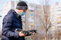 Surveyor in a protective mask prepares a quadcopter for photogrammetry Royalty Free Stock Photo