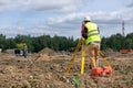 The surveyor is shooting at a building site