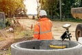 Surveyor site engineer with total positioning station on the construction site of the new road construction with construction