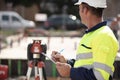 surveyor on site writing on clipboard