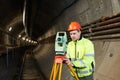 Surveyor with theodolite level at underground railway tunnel construction work Royalty Free Stock Photo