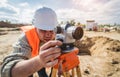 Surveyor worker with theodolite equipment at construction site Royalty Free Stock Photo