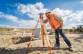 Surveyor worker with theodolite equipment at construction site Royalty Free Stock Photo