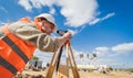 Surveyor worker with theodolite equipment at construction site Royalty Free Stock Photo