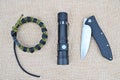 Survival kit. Folding knife, flashlight and paracord bracelet