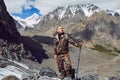 Survival in the wild. A man in camouflage resting among the mountains. Stalker, survive in the woods Royalty Free Stock Photo