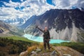 Survival in the wild. A man in camouflage resting among the mountains. Stalker, survive in the woods Royalty Free Stock Photo