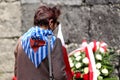 Survived prisoners fold flowers by the wall of death