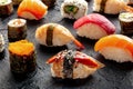 Sushi. An assortment of rolls, maki, nigiri etc on a black background