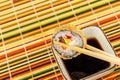 Sushi baked tempura roll with salmon and avocado with chopsticks over a bowl of soy sauce Royalty Free Stock Photo