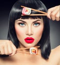 Sushi. Beauty model girl eating sushi rolls Royalty Free Stock Photo