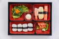 Sushi Bento Served with Japanese Rice Wraped with Seaweed and Shrimp, Kani and Tamagoyaki Sushi with Seaweed Salad. Royalty Free Stock Photo