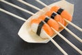 Sushi on boat shaped plate with chopsticks Royalty Free Stock Photo