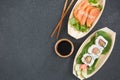 Sushi on boat shaped plate with chopsticks Royalty Free Stock Photo