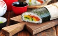 Sushi Burrito with salmon, cucumber, pepper and cream cheese Royalty Free Stock Photo