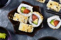 Sushi california rolls filed raw salmon fish, avocado, cream cheese and topped with sesame Royalty Free Stock Photo