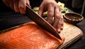 Sushi chef cuts raw salmon with knife Royalty Free Stock Photo