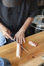 Sushi chef cutting fish sashimi style