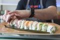 Sushi chef plating a roll of sushi Royalty Free Stock Photo