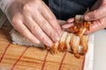 Sushi chef puts eel fish on a roll with rice and filling Royalty Free Stock Photo
