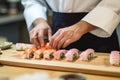 Sushi chef\'s hands at work: a delicious japanese meal