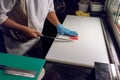 Sushi chef slicing a raw fresh fish with a sharp knife on a whit Royalty Free Stock Photo