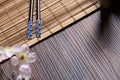 Sushi chopsticks on bamboo table with sukura Royalty Free Stock Photo