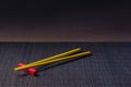 Sushi chopsticks on black bamboo straw mat Royalty Free Stock Photo