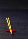 Sushi chopsticks on black bamboo straw mat Royalty Free Stock Photo