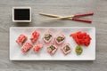 Sushi with chopsticks, ginger, soy sauce and wasabi. Japanese food. Sushi roll set with vegetables, fish and caviar Royalty Free Stock Photo