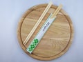 Sushi chopsticks on wooden plate Decorative cutlery set Royalty Free Stock Photo