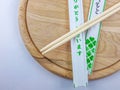 Sushi chopsticks on wooden plate Decorative cutlery set Royalty Free Stock Photo